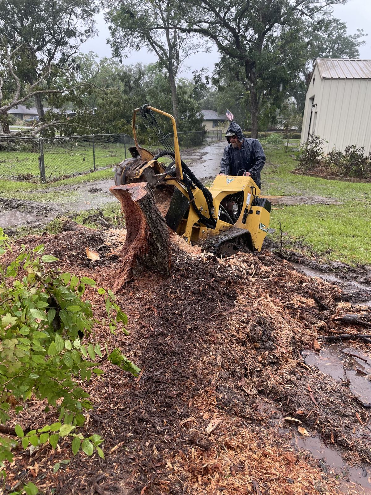 Stump grinding with heavy equipment in San Antonio yard